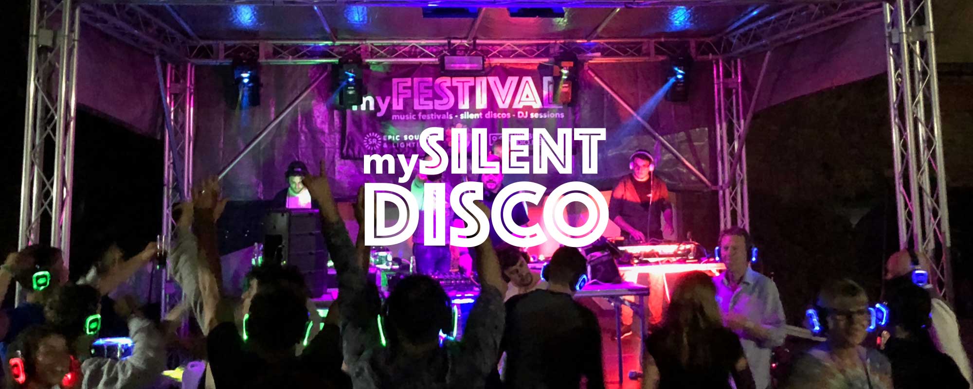 Outdoor silent disco with DJs on stage